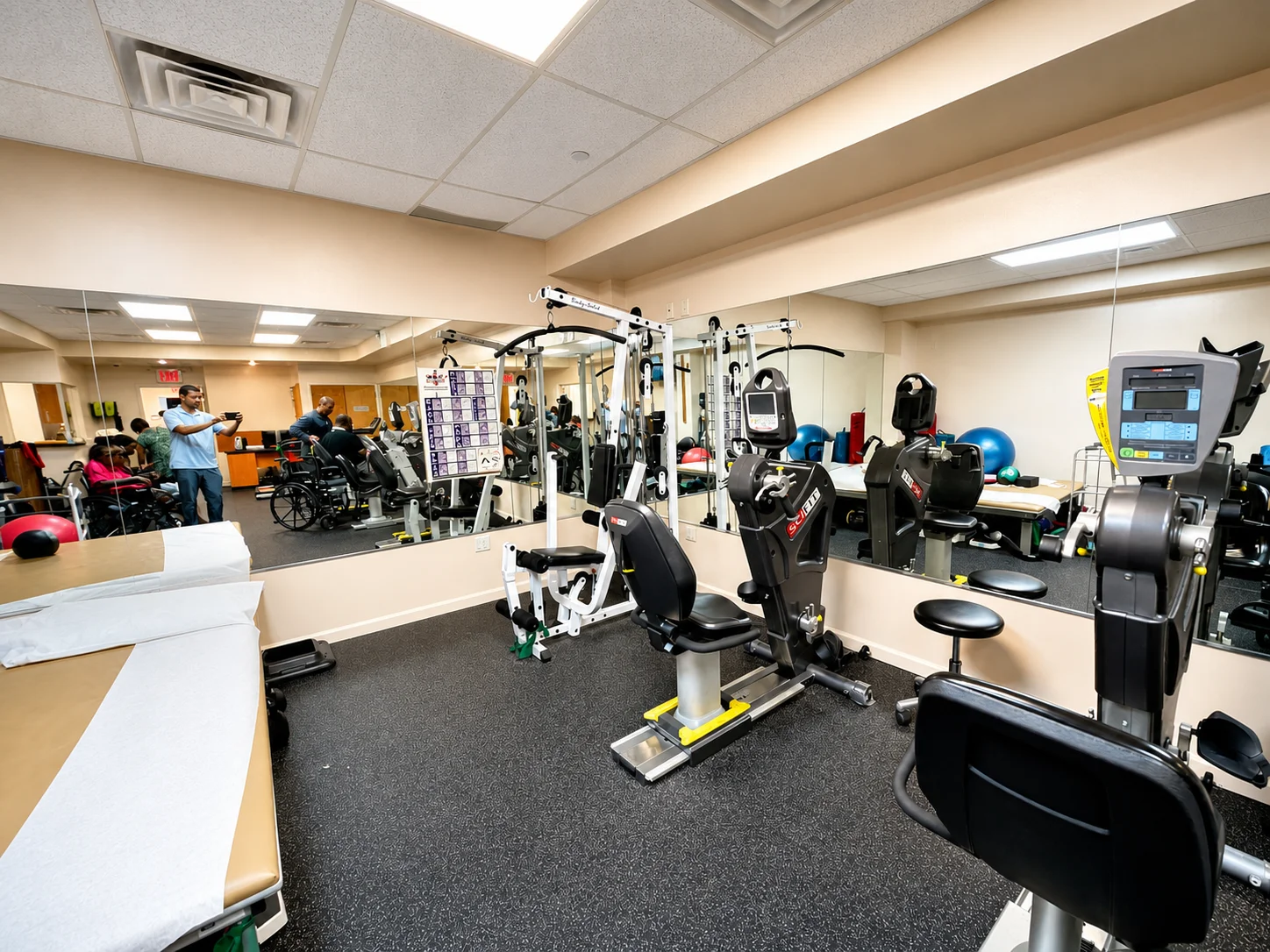 Physical therapy gym with exercise equipment at Be Well Primary Health Care Center