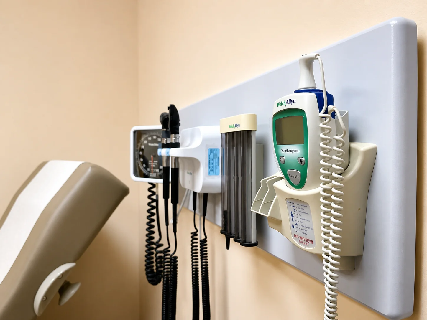 Wall-mounted diagnostic instruments in a Be Well Primary Health Care Center exam room